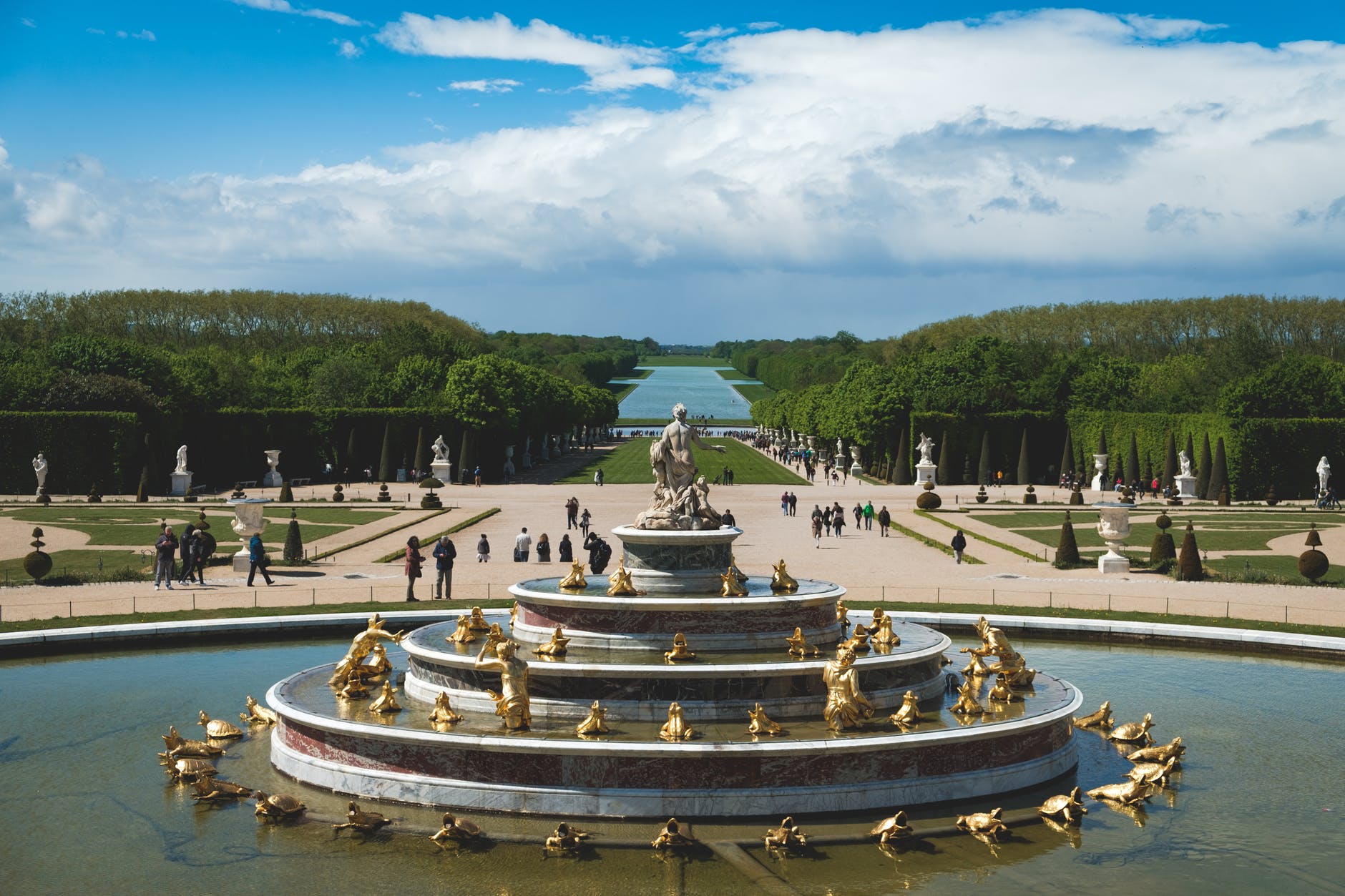 gold and white fountain in the middle of the park